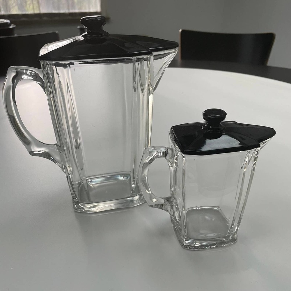 A set of two vintage Glass pitchers/containers with black lid